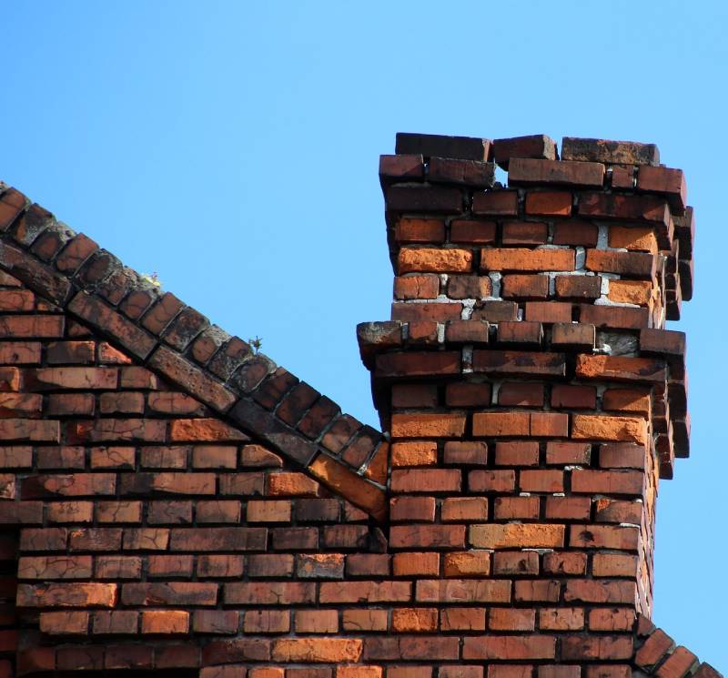 Damaged chimney on an Winnetka home showing cracks and missing mortar